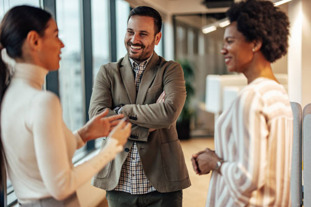 istock Three diverse colleagues, joking together in the office and laughing. 1360026810