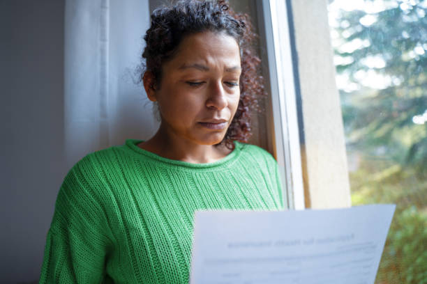 One black woman getting bad news feeling anxiety Black woman getting bad news letter feeling worried eviction photos stock pictures, royalty-free photos & images