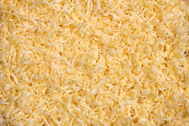 istock The texture of grated cheese. Orange cheese. Close up 1360027295