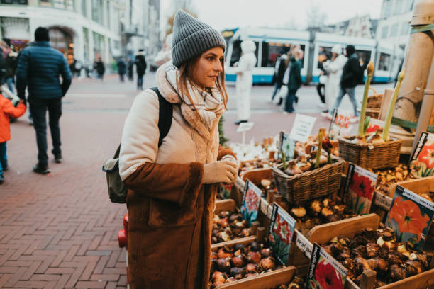 istock Woman buying tulip bulbs on her vacation in Amsterdam 1360027310
