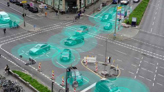 Conceptual visualisation video of self driving autonomous electric cars on a multi lane city street intersection. The cars are using radar sensors, wireless communication, GPS and artificial intelligence to navigate and communicate with each other to drive safely.
