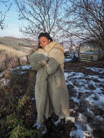 young african woman with a fur coat in winter