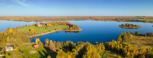 top view of fall forest and lake. autumn sunny evening over a forest lake. - tree stream forest woods imagens e fotografias de stock