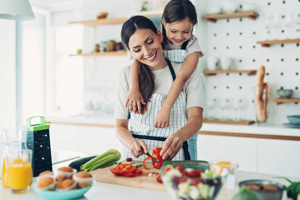 istock Little girl trying to help in the kitchen 1360028875