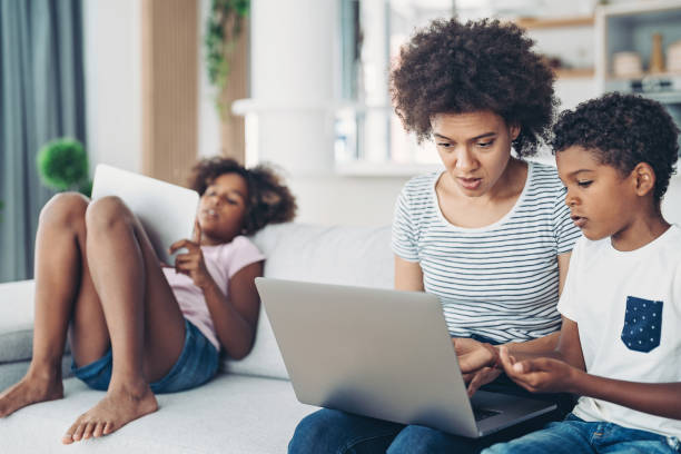 istock Black mother helping her son's education 1360028882