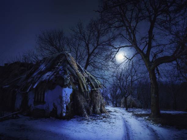 Abandoned old house in the light of the moon on a winter night stock photo