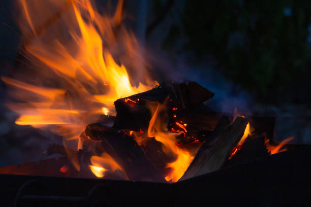 istock fire in the grill at night close-up, fire flame 1360030528