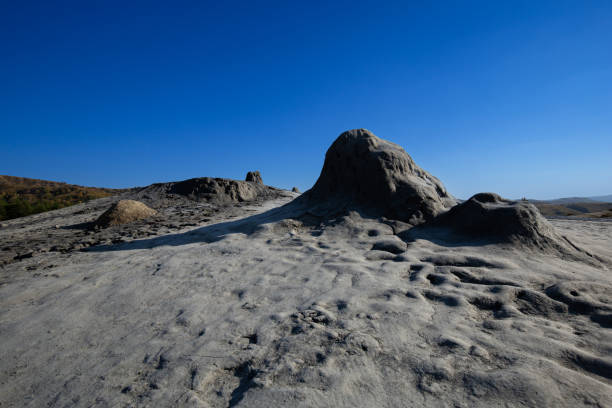 istock Volcanic cones and drying mud under blue sky in Berca Mud Volcanoes reservation 1360030809