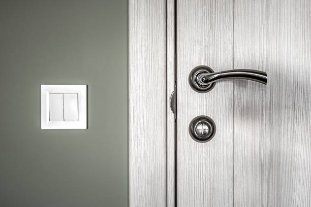 istock elements of the interior, steel door handle, wall and white switch 1360031782