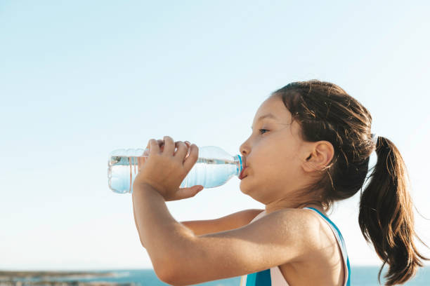 istock Girl Drinking Water 1360031903