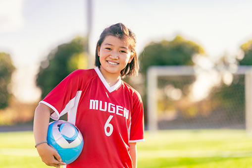 A portrait of an elementary age female football or soccer player.