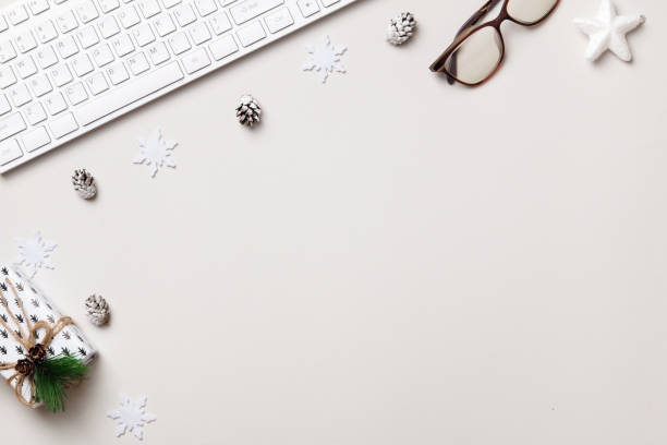 istock Christmas desktop. Keyboard glasses gift on a gray table. Flat lay top view copy space 1360034526