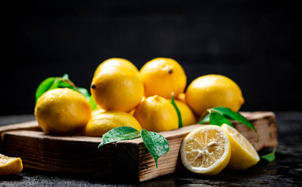 istock Lemons with leaves on a wooden tray. 1360034876