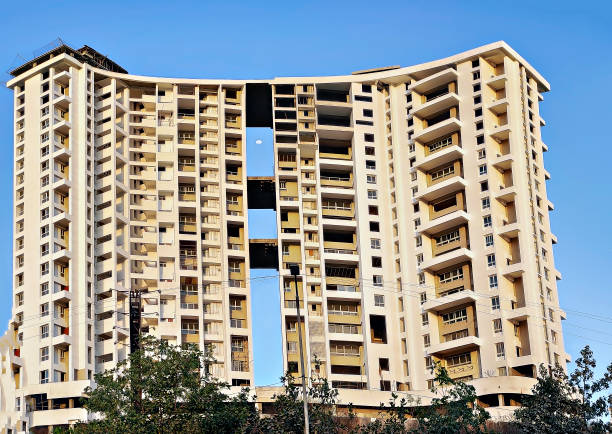 istock Tall building under construction on a background of blue sky. 1360034962