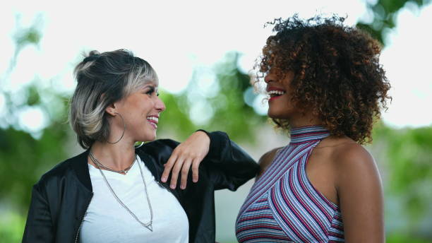 istock Two happy diverse women standing outside smiling 1360035119