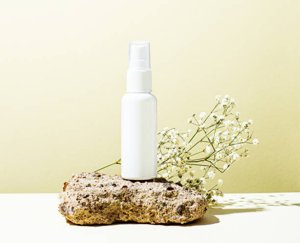 istock On a light yellow background, a white medicine bottle with a place to insert text, rough natural stone and a white flower. The concept of health and beauty. Template for medical and cosmetic products 1360035669