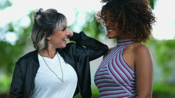 istock Two happy diverse women standing outside smiling 1360035676
