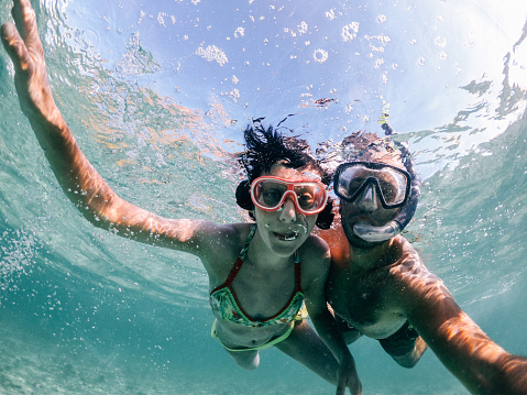 Woman swimming in the beautiful sea of Mauritius protected by the reef on the Indian Ocean