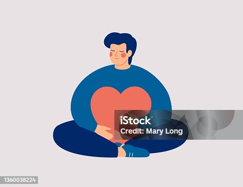 istock Young man embraces a big red heart with mindfulness and love. Smiling boy sits in lotus pose with closed eyes and enjoys his freedom and life. 1360038224