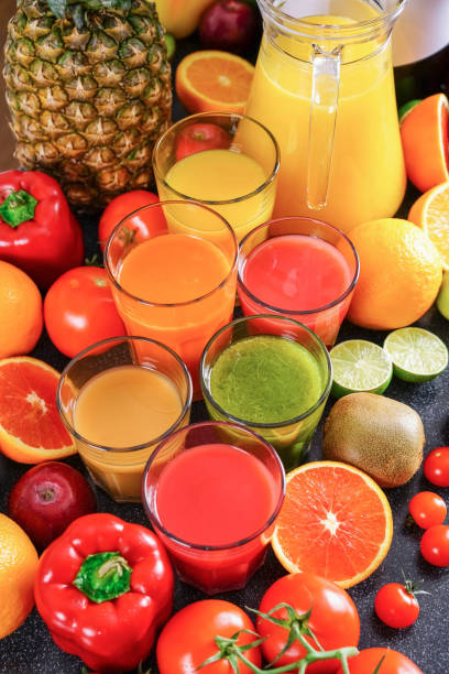 istock Freshly squeezed vegetable and fruit juices in glass bins and jug. 1360039033