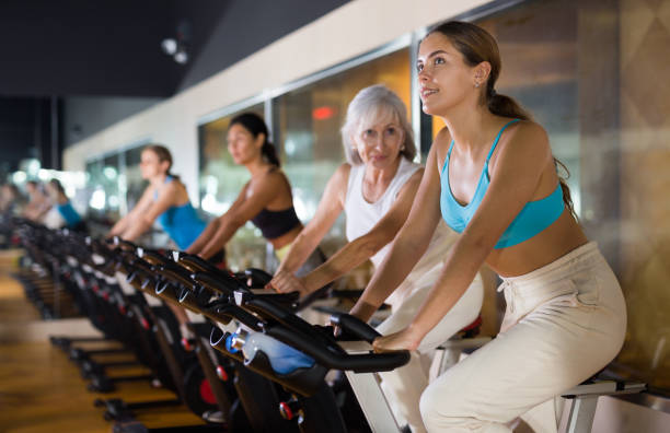 istock Young girl on training using bike in gym 1360039191