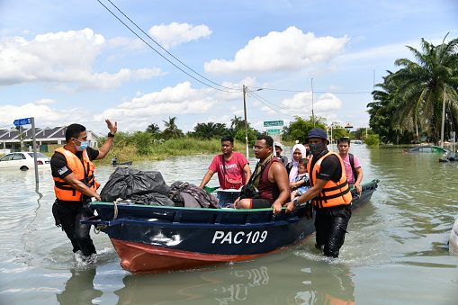 Members of Royal Malaysian Police helping evacuation the flood victims at RTB Bukit Changgang, Dengkil, Sepang on December 20th, 2021.