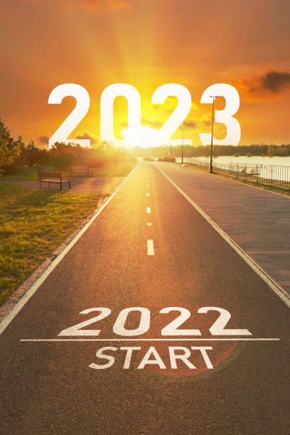 Concept for 2022-2023 New year New year 2022 start concept. The numbers 2022 and 2023 years is written on the asphalt on the empty sports path in the bright rays of the sun. Motivational concept for vision and action on future 2023 2022 stock pictures, royalty-free photos & images