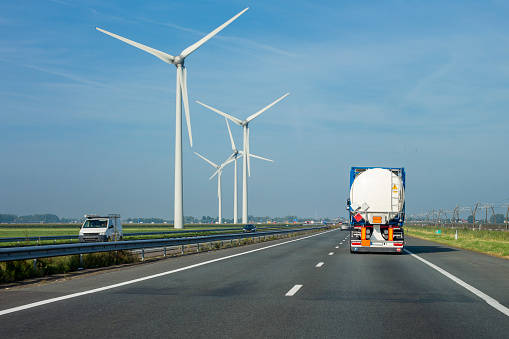 Dutch silo truck on highway - in the background some wind turbines