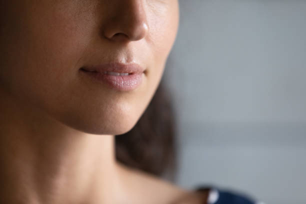 istock Close up on lower facial part with moisturized lips 1360045078