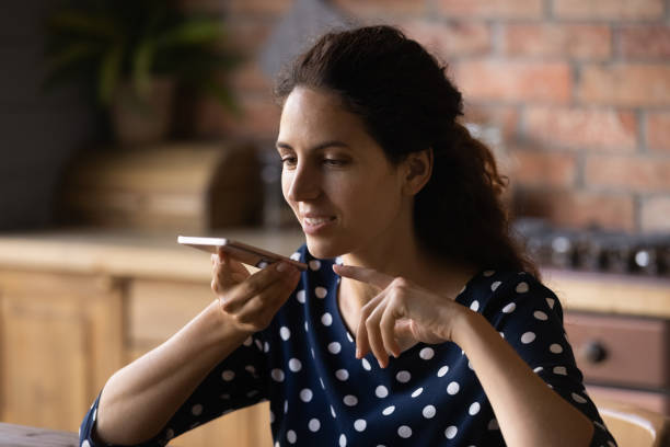 istock Pleasant happy young latin woman sending voicemail. 1360046151