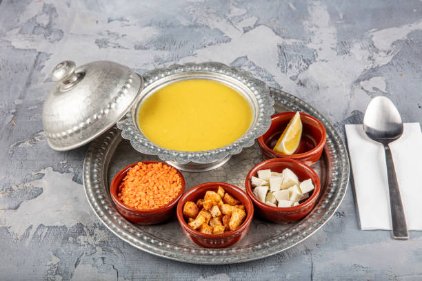 istock Lentil soup in a copper tray and copper bowl grey background. 1360046697