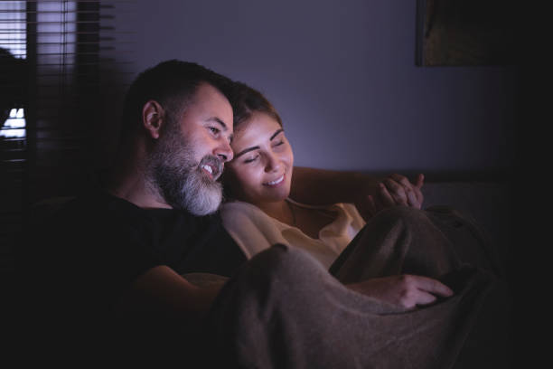 istock Couple watching movie at home 1360047285