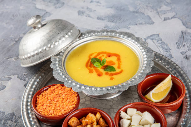 istock Lentil soup in a copper tray and copper bowl grey background. 1360048278