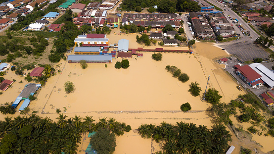 Dengkil, Malaysia - December 20, 2021: Aerial view of Dengkil district from flooding that causes damage of the infrastructure and housing area. Selective focus, contains dust and grain