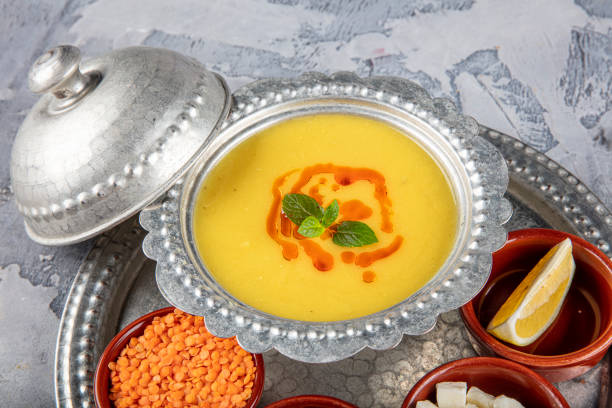 istock Lentil soup in a copper tray and copper bowl grey background. 1360052790