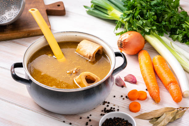 istock Healthy homemade bone broth in a cooking pan 1360053120