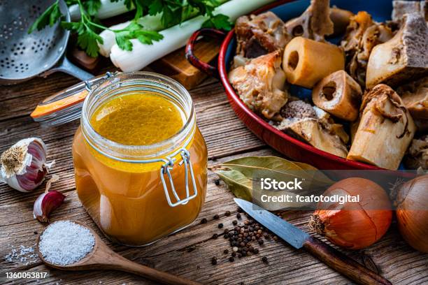 Bone Broth And Ingredients On Rustic Table Stock Photo - Download Image Now - Bone Broth, Broth, Bouillon