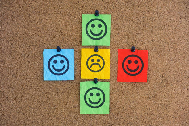 istock One paper note with a sad face with happy faces around it on a corkboard 1360054299