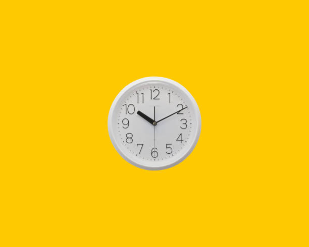 istock Top view white clock on bright yellow color background 1360055772