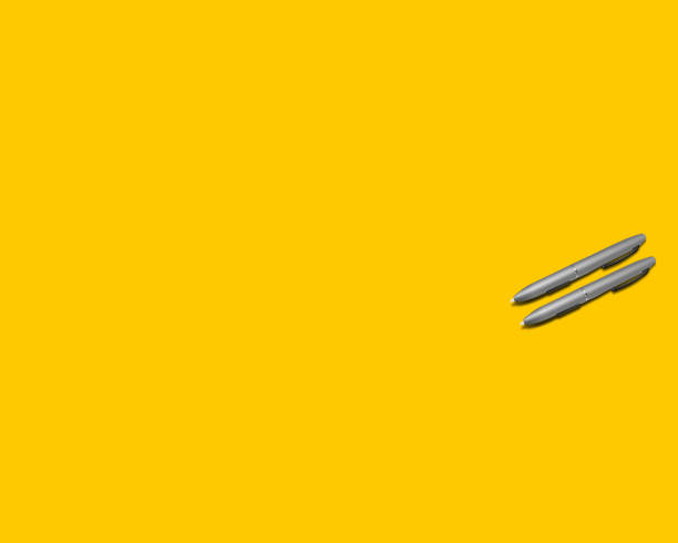 istock two pens on a yellow background 1360056897