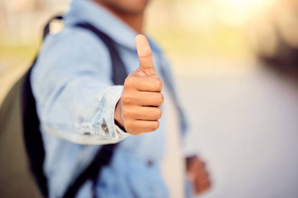 Cropped shot of a man showing thumbs up while standing outside Be good. Do good city tour deals stock pictures, royalty-free photos & images