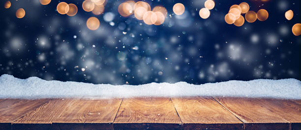 istock Oak wood platform or podium with snow and bokeh lights 1360057848