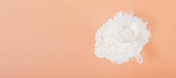 istock Top view protein powder heap with measuring scoop 1360059112