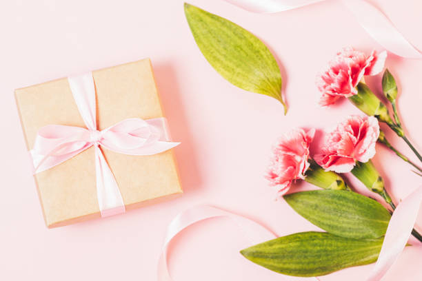 istock Festive composition with gift box and bouquet of flowers 1360059164