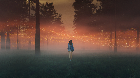 Surreal abstract floating lights with woman walking in fantasy forest