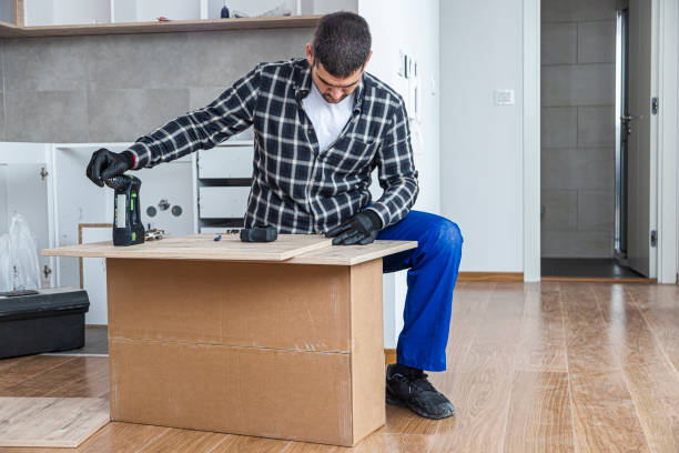 istock The carpenter finalizing the assembly of the kitchen shelf 1360059472