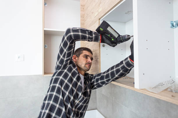 istock The carpenter finalizing the assembly of the kitchen shelf 1360059490