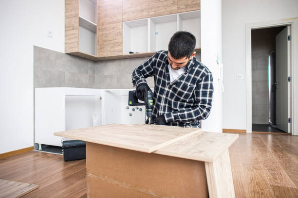 istock The carpenter finalizing the assembly of the kitchen shelf 1360059495