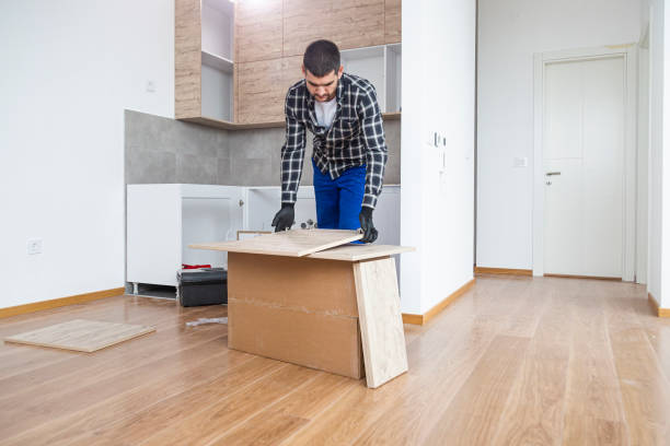 istock The carpenter finalizing the assembly of the kitchen shelf 1360059520