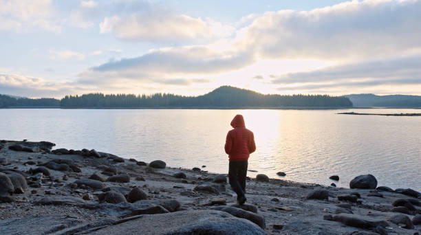 istock Man relaxing in nature at sunset. Getting away from it all. 1360059543